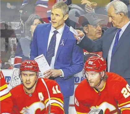  ?? DARREN MAKOWICHUK • POSTMEDIA ?? Middleton’s Cail MacLean, left, is an assistant coach with the Calgary Flames.