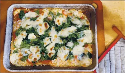  ?? ELIZABETH KARMEL — THE ASSOCIATED PRESS ?? A sheet-pan pizza, a fun meal to make with kids.