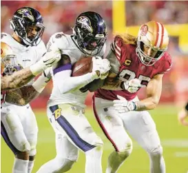  ?? THEARON W. HENDERSON/GETTY ?? Ravens linebacker Patrick Queen hits 49ers tight end George Kittle after Queen’s intercepti­on on Dec. 25 in Santa Clara, California.