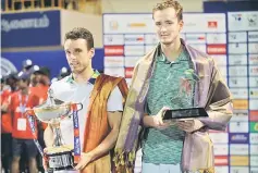  ?? — AFP photo ?? Roberto Buatista Agut of Spain (left) holds the winning trophy after beating Daniil Medvedev of Russia in the final men’s singles match at Chennai Open Tennis Championsh­ip in Chennai.