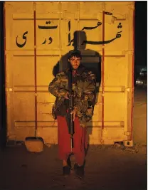  ?? ?? A Taliban fighter poses for a photo Nov. 27 at a checkpoint in Herat.