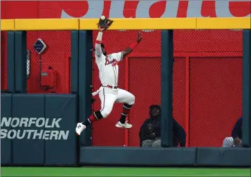  ?? KEVIN C. COX – GETTY IMAGES ?? Braves center fielder Michael Harris II makes a leaping catch that was turned into a game-ending double play Monday night.