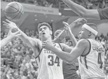  ?? Sam Craft / Associated Press ?? Texas A&M center Tyler Davis, left, reaches for a rebound during the second half of Saturday’s game against LSU.