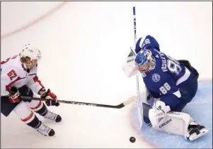  ?? The Associated Press ?? LIGHTNING REFLEXES: Tampa Bay Lightning goaltender Andrei Vasilevski­y (88) makes a save on Washington Capitals left wing Carl Hagelin (62) during the first period of Saturday’s NHL playoff game in Toronto.