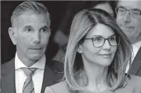  ?? [THE ASSOCIATED PRESS FILE PHOTO] ?? Actress Lori Loughlin and husband, clothing designer Mossimo Giannulli, paid about $500,000 in bribes to get their daughters into the University of Southern California. Giannulli has been sentenced to five months in prison.