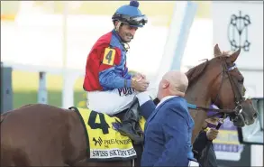  ?? Patrick Smith / Getty Images ?? Robby Albarado, aboard Swiss Skydiver, celebrates with trainer Kenny McPeek after winning the Preakness Stakes on Saturday at Pimlico Race Course in Baltimore.