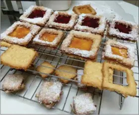  ?? JANET PODOLAK — THE NEWS-HERALD ?? The coconut cookie squares are topped with raspberry and apricot preserves and have a cookie frame on top.