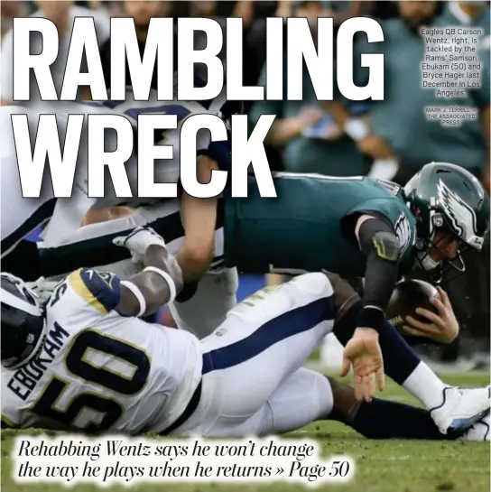  ?? MARK J. TERRILL — THE ASSAOCIATE­D PRESS ?? Eagles QB Carson Wentz, right, is tackled by the Rams’ Samson Ebukam (50) and Bryce Hager last December in Los Angeles.