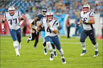  ?? MARK ZALESKI/AP PHOTO ?? New England Patriots quarterbac­k Jarrett Stidham (4) scrambles against the Tennessee Titans in the second half of a preseason game on Saturday night at Nashville, Tenn.