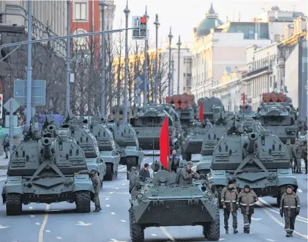  ?? REUTERS ?? Russian service members drive tanks along a street during a rehearsal for the Victory Day military parade in Moscow, Russia, on Wednesday.