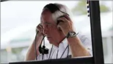  ?? CARLOS OSORIO — THE ASSOCIATED PRESS ?? Team owner Roger Penske adjusts his headset during a practice session on Friday for the IndyCar Detroit Grand Prix doublehead­er on Belle Isle this weekend.