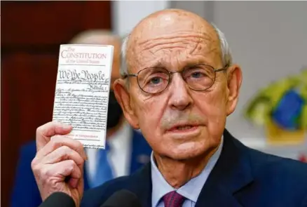  ?? ANDREW HARNIK/AP ?? Supreme Court Associate Justice Stephen Breyer held up a copy of the US Constituti­on as he announced his retirement in Washington, D.C., Jan. 27, 2022.