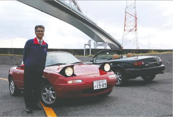  ?? CLAYTON SEAMS/DRIVING.CA ?? Nobihuro Yamamoto, the man who led the developmen­t of the Miata MX-5, shows off two factory-restored MX-5s in Japan.