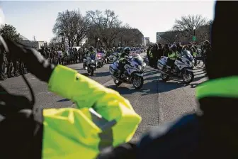  ?? Graeme Sloan / Bloomberg ?? Members of the law enforcemen­t community salute Sunday during the procession for U.S. Capitol Police Officer Brian Sicknick, who died afterWedne­sday’s riot, inWashingt­on, D.C.