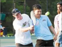  ?? RACHEL WISNIEWSKI/FOR DIGITAL FIRST MEDIA ?? Touch of Tennis Founder Jim Holt (left) helps participan­t Suyoung Kim with his form Wednesday.