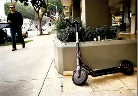  ?? TRIBUNE NEWS SERVICE ?? A Bird scooter stands along 5th Ave. in Santa Monica. The scooters are upsetting San Francisco city officials because people are leaving them all the city.