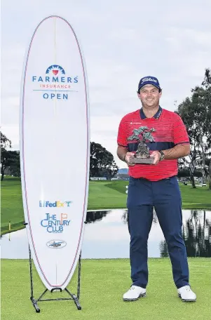  ?? PHOTO: GETTY IMAGES ?? Surf’s up . . . Patrick Reed poses with his trophy and a surfboard provided by a sponsor after winning the Farmers Insurance Open at Torrey Pines South in San Diego, California, yesterday.