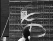  ?? Associated Press ?? ONE YEAR Former Japanese Olympic gymnast Kotono Tanaka performs as a “1-Year to Go” banner hangs outside the Ariake Gymnastics Center on Monday in Tokyo.