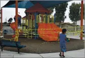  ?? JAE C. HONG — THE ASSOCIATED PRESS FILE ?? A boy walks with his skateboard past a playground sealed off due to the coronaviru­s pandemic in Commerce. California public health officials say it’s OK for public playground­s to open across the state.