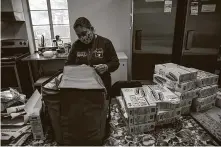  ??  ?? Dora Rodriguez, who works with a group called Tucson Samaritans, prepares food to be given to migrants at the border. She said she expects to see more migrants coming to the U.S.