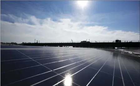  ??  ?? A rooftop is covered with solar panels at the Brooklyn Navy Yard on Tuesday in New York. AP PHOTO