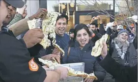  ??  ?? Naan is pulled apart Friday morning as part of the grand opening of Choolaah in East Liberty.