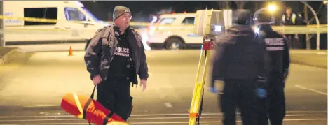  ?? SHANE MACKICHAN ?? Police gather evidence in Surrey after Karanparta­p Waraich, 22, was fatally shot Monday while driving down 96th Avenue.