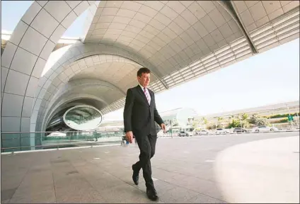  ?? (AP) ?? In this file photo, Dubai Airports CEO Paul Griffiths walks out of the Dubai Internatio­nal Airport’s Terminal 3 in Dubai, June 17, 2014. Dubai Internatio­nal Airport, the world’s busiest for internatio­nal travel, announced on Thursday it handled over 13.6 million passengers in the first three months of 2022.