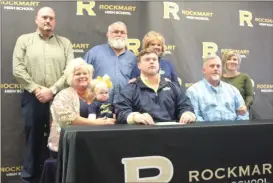  ?? Kevin Myrick / SJ ?? Cade Holder is joined by his family for National Signing Day.