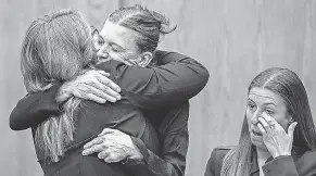  ?? KATHRYN ZIESIG VIA AP ?? Dr. Giovannina Anthony, second from left, a plaintiff in a lawsuit challengin­g Wyoming's new abortion ban law, hugs her attorney.