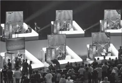  ?? HENRY NICHOLLS / REUTERS ?? Gamers do battle in on-stage booths at the FIFA eWorld Cup Grand Final at London’s O2 Arena on Thursday.