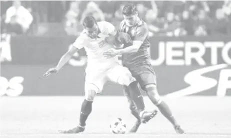  ??  ?? Real Madrid’s Alvaro Morata (R) and Sevilla’s Gabriel Mercado in action.