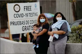  ?? AP PHOTO BY MARCIO JOSE SANCHEZ ?? Two women and a child wait to take a Coronaviru­s test at a mobile testing site at the Charles Drew University of Medicine and Science Wednesday, July 22, 2020, in Los Angeles. California’s confirmed coronaviru­s cases have topped 409,000, surpassing New York for most in the nation.