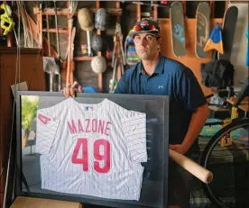  ?? SANDY HUFFAKER / THE WASHINGTON POST ?? Brian Mazone shows his Phillies jersey he never got to wear in a major league game because rain postponed his big chance in 2006.