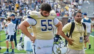  ?? HYOSUB SHIN / HYOSUB.SHIN@AJC.COM ?? Offensive lineman Kenny Cooper leaves the field after The Citadel’s win Saturday in overtime at Bobby Dodd Stadium. The Yellow Jackets scored just six points in the first half.