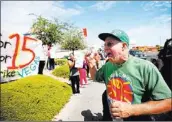  ??  ?? Tom Young shouts support during the protest at the KFC.