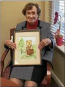  ?? SUBMITTED BY ARBOUR SQUARE ?? Diane Rathschmid­t holds her favorite watercolor painting of a teddy bear that she completed during a Watercolor 101 class offered at Arbour Square.