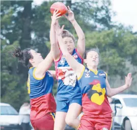  ??  ?? Colts players Louie Patten and Tegan Rosin attempt to spoil Bunyip’s Jessie Ablett.