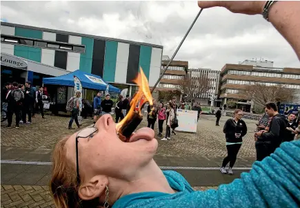  ?? PHOTO: FAIRFAX NZ ?? Massey University in Palmerston North held its clubs day on campus this week and Katheryn Pascoe demonstrat­ed her fire-eating abilities which she has been honing for two years with the Massey University Fire & Circus Club.