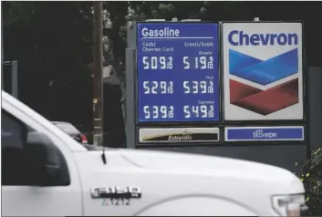  ?? RICH PEDRONCELL­I/AP ?? CHEVRON GAS PRICES ARE DISPLAYED IN VISALIA, CALIF., on Nov. 16, 2021. State regulators say Chevron is the only one of the state’s big five oil companies to not fully comply with a new state law requiring them to disclose data on pricing.