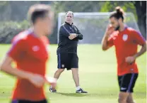  ?? JOHN RAOUX, AP ?? U.S. coach Bruce Arena, center, watches players go through drills on Monday.