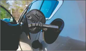  ?? The Associated Press ?? GAS PRICES CLIMBING: In this April 23 photo, a car is filled with gasoline at a station in Windham, N.H. Crude oil prices are at the highest level in more than three years and expected to climb higher, pushing up gasoline prices along the way.