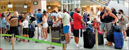  ??  ?? DESPERATE TO GET AWAY: But travellers fear sudden rule changes