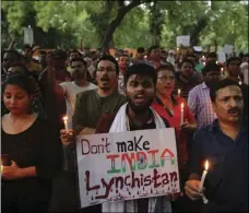  ??  ?? In this June 26 file photo, Indian protesters shout slogans as they hold placards and candles during a protest condemning mob lynching of Muslim youth Tabrez Ansari in Jharkhand state, in New Delhi, India. P PHOTO/ALTAF QADRI