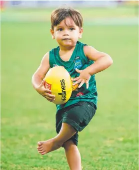  ??  ?? Chance May, 2, watched his heroes in action and showed his own skills at the NTFL grand final last night