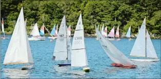  ??  ?? Skippers guide their J-class model yachts over the course on the Mystic River off the Seaport as part of the annual Mystic River Radio Sailors.