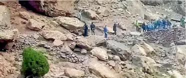  ?? AP ?? Security personnel work at the scene where the bodies of two Scandinavi­an women tourists were found dead, near Imlil in the High Atlas mountains, Morocco.