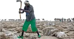  ??  ?? AFAR IRDOOD, Ethiopia: A man mines blocks of salt from the Danakil Depression.