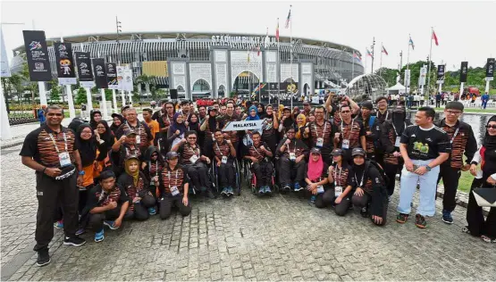  ??  ?? All set to go: The national para athletes posing for a picture after the flag-raising ceremony at the National Stadium in Bukit Jalil yesterday.