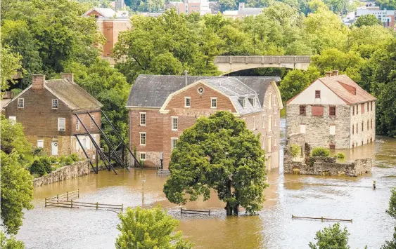  ?? APRIL GAMIZ/THE MORNING CALL ?? Flooding is seen in the Colonial Industrial Quarter in Bethlehem after Tropical Storm Isaias brought torrential rain to the Lehigh Valley on Tuesday.